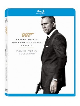Daniel Craig standing and holding gun on a white background.